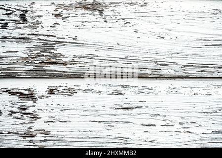 A closeup of aged, distressed wooden planks with chipping white paint Stock Photo