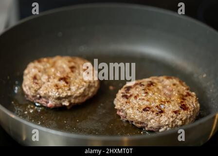 hamburger meat grilling for burgers. Homemade cutlets in frying pan Stock Photo