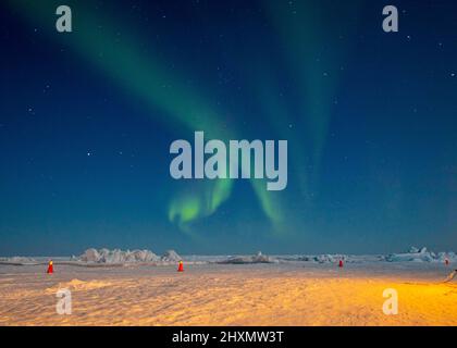 BEAUFORT SEA, Arctic Circle (March 11, 2022) – The Northern Lights illuminate the Arctic sky over the Navy's Ice Camp Queenfish during Ice Exercise (ICEX) 2022. Ice Camp Queenfish is built on a sheet of floating ice approximately 160 nautical miles offshore in the Arctic Ocean, and includes sleeping tents for about 60 personnel, a command center, dining tent and runway for aircraft. ICEX 2022 is a three-week exercise that allows the Navy to assess its operational readiness in the Arctic, increase experience in the region, advance understanding of the Arctic environment, and continue to develop Stock Photo