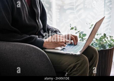 Man working from home, using laptop Stock Photo