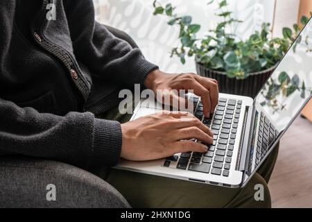 Man working from home, using laptop Stock Photo