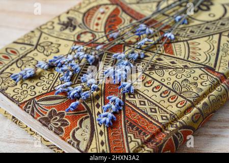 Dried lavender flowers over beautiful flowery diary. Stock Photo