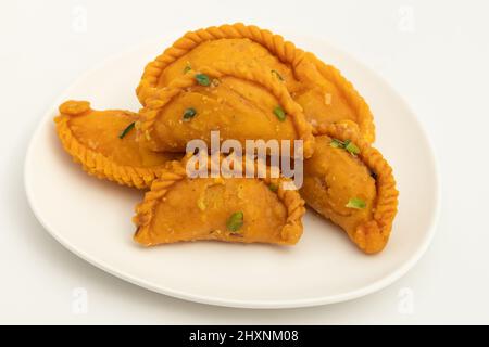 Kesar Gujia Mithai Also Called Kesri Gujiya, Pirukiya, Pirukia, Pedakiya, Karanji, Basundi Gughra Made Of Suji Ghee Stuffed With Mawa Khoya Kesari Cha Stock Photo