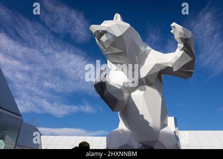 the village-france. 18-02-2022. A statue of a white bear in the shopping center of outlet stores against a backdrop of a blue sky. Called the village. Stock Photo