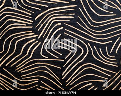 Tribal ornament, trendy dark ethnic background, geometric texture drawn on wooden board. Stock Photo