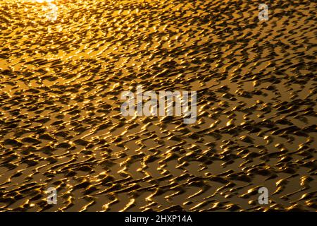 Sand with ripples formed by wave action Stock Photo - Alamy