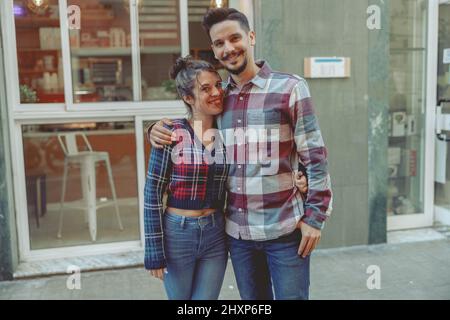 Smiling man and woman standing near cafe Stock Photo