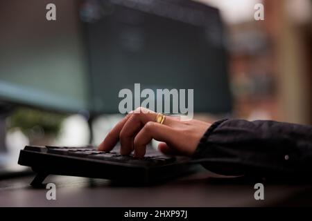 Cyber security agency network developer doing ethical hacking to retrieve encrypted stolen data. System developer writing lines of codes in order to build a anomaly analyser for database. Close up. Stock Photo