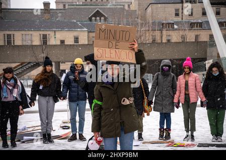 Toronto, Canada. 13th Mar, 2022. A protester holds a placard that says 'Minute of Silence' during the women's “Live With No Fear” rally. Women organize a feminist march to demand justice and make visible violence against Latin American women in front of the City Hall in Toronto. Credit: SOPA Images Limited/Alamy Live News Stock Photo