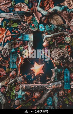 Potion bottle flat lay with a burning star, magical still life with moss and sparkles Stock Photo