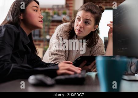 Cyber security company developers encrypting cloud processing data system using blockchain technology. Asian network engineer utilising machine learning to protect mainframe information storage. Stock Photo