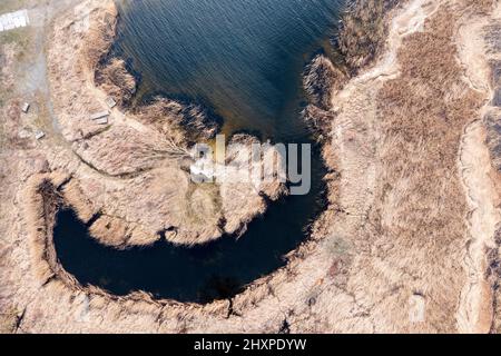 The view from the drone on the thickets by the lake, interesting shapes seen from the drone. Stock Photo