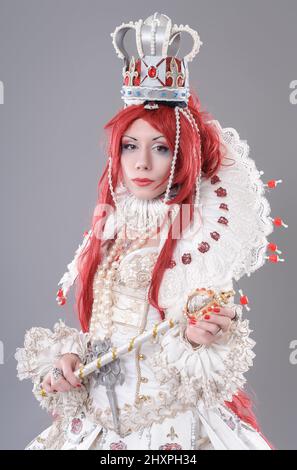 Queen wizard. Model dressed in renaissance style on gray background Stock Photo