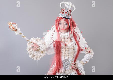 Queen wizard. Model dressed in renaissance style on gray background Stock Photo