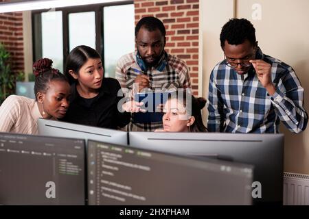 Informational agency multiracial tech engineers programming application while using computer. Cyber security company developers encrypting cloud processing data system using blockchain technology. Stock Photo