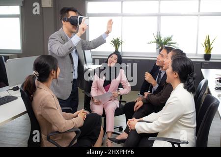 Young businessman is developer design testing of connection metaverse on vr realistic in the office, development global of engineer for creative appli Stock Photo