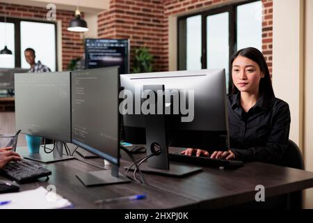 Cybernetics engineer writing lines of code in order to secure mainframe database storage. Software developer engineering an autonomous defence system using advanced artificial intelligence technology. Stock Photo