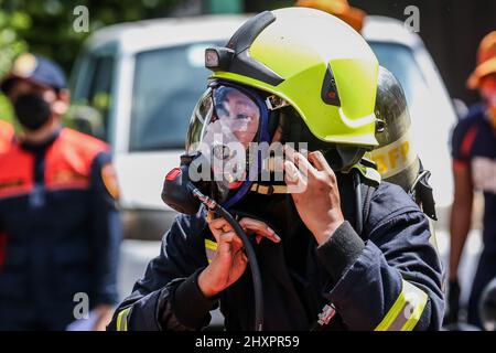 Quezon City. 14th Mar, 2022. A female firefighter participates in the Women Firefighters Skills Olympics at the Philippine Bureau of Fire Protection-National Capital Region (BFP-NCR) headquarters in Quezon City, the Philippines on March 14, 2022. The Philippine Bureau of Fire Protection (BFP) held its Women Firefighters Skills Olympics as part of the observance of the National Women's Month and the Fire Prevention Month to show the skills of their female personnel in extinguishing fires, emergency response, and rescue capabilities. Credit: Rouelle Umali/Xinhua/Alamy Live News Stock Photo