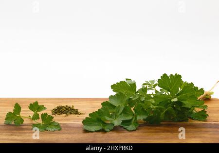 Sprig of fresh parsley isolated on white background, Petroselinum Crispum Stock Photo