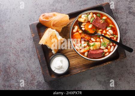 Hungarian goulash soup with beans, meat and vegetables close-up in a bowl on the table. horizontal top view from above Stock Photo