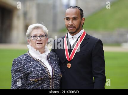 File photo dated 15-12-2021 of Sir Lewis Hamilton with his mother Carmen Lockhart after he was made a Knight Bachelor by the Prince of Wales during a investiture ceremony at Windsor Castle. Hamilton has revealed he is in the process of changing his name. The seven-time world champion says he intends to incorporate his mother's maiden name, Larbalestier, alongside Hamilton. Issue date: Monday March 14, 2022.