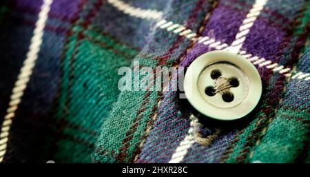 Closeup of button on plaid flannel shirt Stock Photo