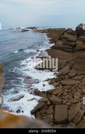 Vertical photo of a rocky shore Stock Photo - Alamy