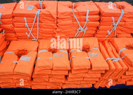 life jacket's sorted on the ship with water drops. Stock Photo