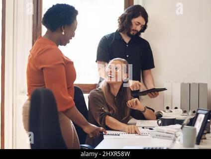Success thrives in an environment filled with dedication. Shot of a group of businesspeople working together in an office. Stock Photo