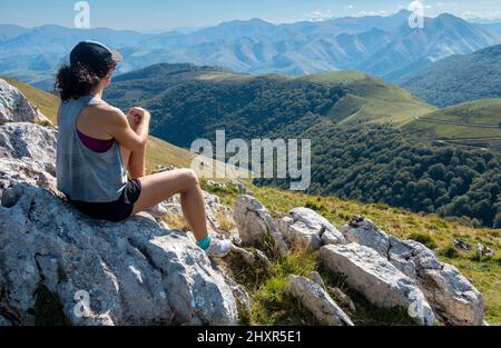 Pilgrim taking in the view over the Pyrenees on the first stage of the Camino Frances from Saint-Jean-Pied-de-Port to Roncesvalles Stock Photo