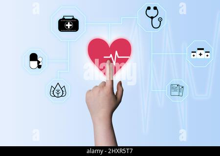 Hand touching virtual heart with medicine graph to diagnose. Medical healthcare concept. Digital healthcare and network connection on hologram modern Stock Photo