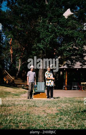 Two Boys Play Corn Hole at a Northwest Resort Stock Photo