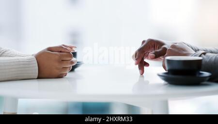 I wish shed let me in. Cropped shot of an unrecognizable couple sitting together at a table. Stock Photo