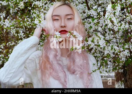 Asian Girl With Spring Flowers Stock Photo