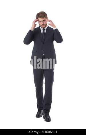 Businessman having a headache full length studio portrait isolated on white background Stock Photo