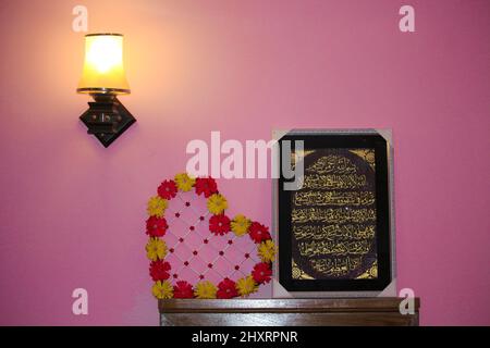 Bedside table overhead lamp that casts light & shadow on the wal Stock Photo