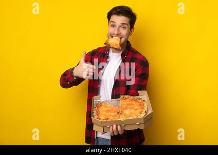 Funny Guy Holding Box Eating Pizza Showing Thumb Up Stock Photo