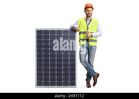 Full length portrait of a male engineer leaning on solar collector and pointing isolated on white background Stock Photo