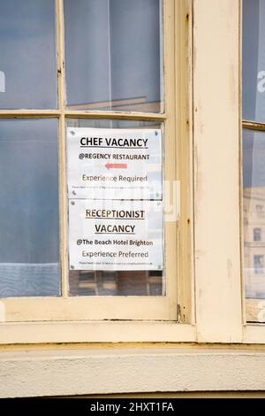 Job vacancy signs in a Brighton window for a chef and receptionist in the hospitality industry. Stock Photo