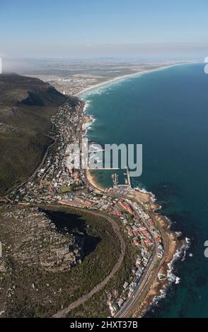 Kalk Bay, Cape Town, South Africa. 2022. Aerial view of the fishing harbour and town at Kalk Bay waterfront. Looking along coast towards Muizenberg Stock Photo