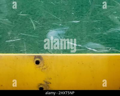 Green and gold background with scratches and light glare Stock Photo