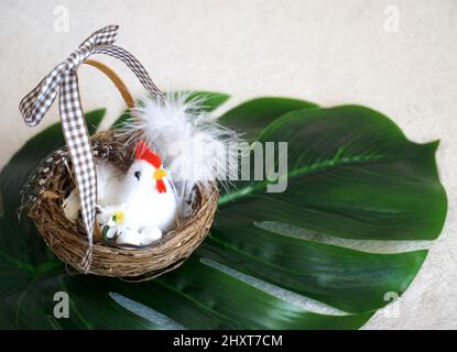 Easter background with little cute little fake chicken and eggs in easter basket Stock Photo