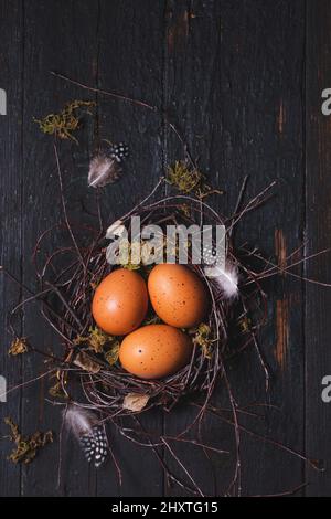 Beautiful Easter eggs in a nest on wooden background. Easter concept in a rustic style Stock Photo