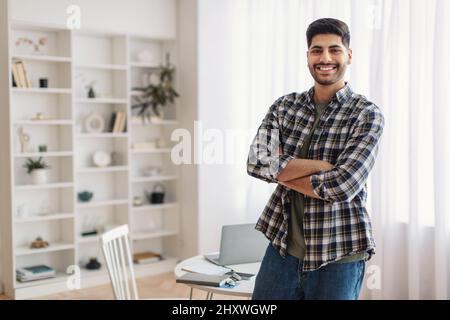Portrait of happy man posing with folded arms Stock Photo