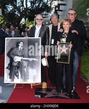 Peter Asher, Phil Everly, Maria Elena Holly and Gary Busey pose as Buddy Holly is honored on the Hollywood Walk of Fame in front of the Capital Records Building, Hollywood, California on September 07, 2011. Stock Photo