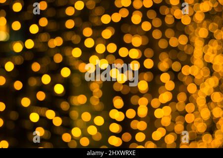 Abstract background with orange and yellow blurred lights with bokeh effect. Festive colors. Christmas celebration concept. Stock Photo