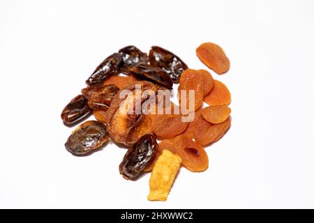 Selective focus on a selection of dried fruits. Dried fig, apricot and dates on a white background Stock Photo