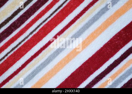 Close-up image of striped colored terry towel. Diagonal stripes. Abstract background. Stock Photo