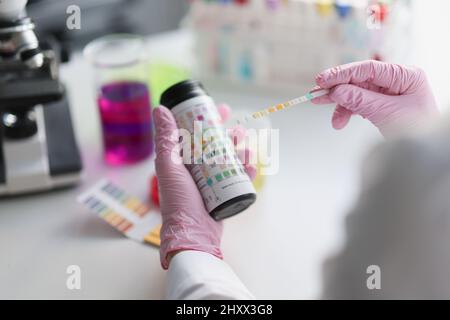 Scientist hold litmus test paper for soil analysis, litmus paper show acidity, chemical analysis Stock Photo