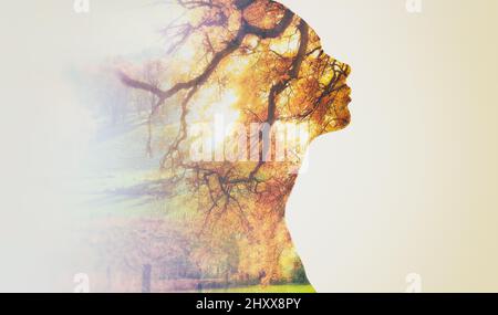 In touch with nature. Composite image of nature superimposed on a womans profile. Stock Photo